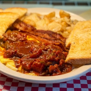 HUEVOS RANCHEROS: 2 EGGS W/ RANCHERO SAUCE, HOMEFRIES, TOAST & JELLY